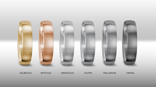 Eine Auswahl an Eheringen in verschiedenen Edelmetallen wie Gold, Weissgold, Rotgold, Platin, Palladium und Tantal. Die Ringe sind in einem sanften Farbverlauf angeordnet und bieten eine Vielfalt an Optionen.